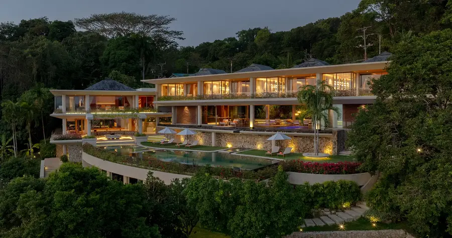 Villa Cascade lit at dusk above the infinity pool