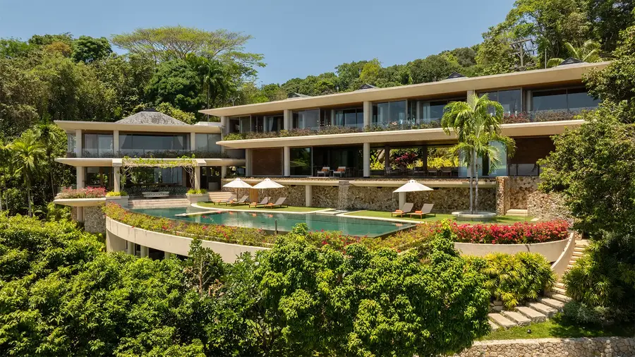 Aerial view of Villa Cascade layered down the hillside above the infinity pool