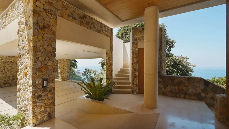 Stone foyer and stairs down to the pool layer