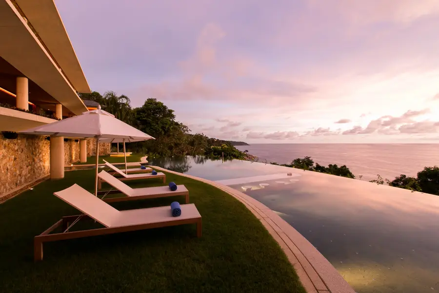 Pool lawn and loungers at sunset