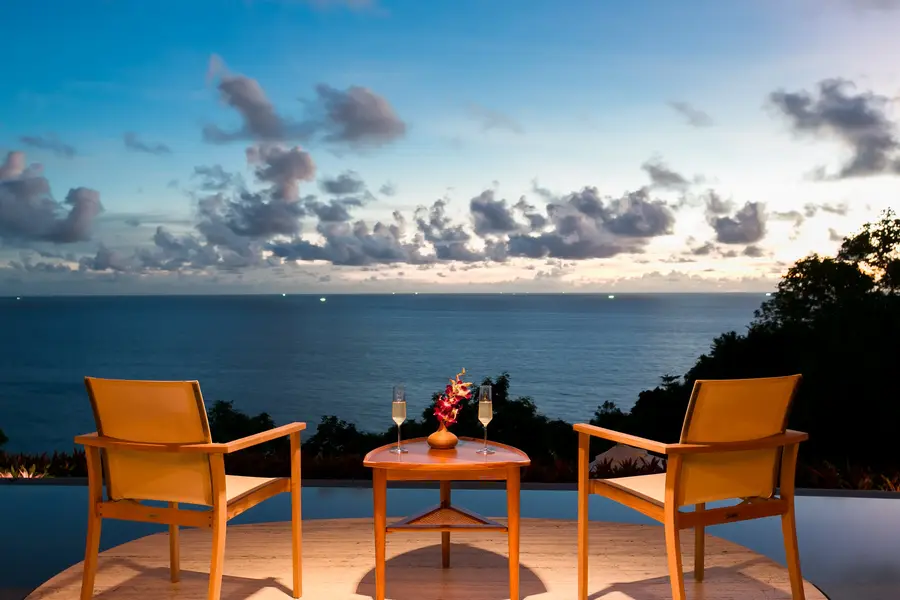 Chairs set for sunset drinks over the sea